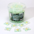Green and yellow 5D flower-shaped laundry pods in a large bucket with camellia scent - 5-in-1 Rotating Camellia 50 Capsules Tub