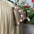 Rose gold hair claw clip with natural purple crystals and pearls shown on blonde hair - Labradorite + Deep Sea Pearl Rose Gold Hair Claw
