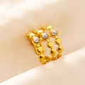 Close-up of vintage gold triple-layered ring with white marble stone inlay detail - Triple Layer Beaded / Gold White