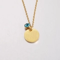 Detailed close-up of a gold necklace with a blue crystal and round mirror tag - 12# Birthstone