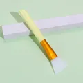Silicone face mask brush with pale yellow handle and translucent white flat head - Yellow