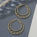 Double hoop gold earrings with five small beads on a textured grey background - Gold