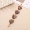 Detail of heart-shaped charm chain with houndstooth fabric and golden twisted rope edge - Heart / K755 Heart Brown White Houndstooth