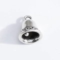 Detailed macro view of vintage silver bell pendant with textured wave pattern and ring - Retro Bell