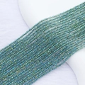 Macro detail of 2mm faceted crystal beads with vibrant blue-green AB electroplated finish - 2mm (Approx. 210 Beads per Strand) / Transparent Green