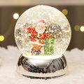 Christmas snow globe with Santa Claus and silver base featuring sparkling glitter snow - Silver Base Santa with Gift Style