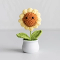 Handmade crochet sunflower in a white ceramic pot with a cute smiling face design - Smiley Sunflower