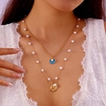 Layered gold starfish and shell necklaces with blue enamel and pearls on model neck - Double-layer Shell Blue NC25Y0011