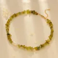 Detail of green peridot gravel necklace with a white freshwater pearl on satin - Korean Jade