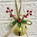 Close-up of golden Christmas bell with red berries and green holly leaves decoration - Golden Bell