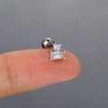 Macro shot of silver titanium steel cartilage earring with zircons held by a fingertip - Silver (Double Stone)