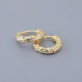 Close-up of golden hoop earrings featuring a diamond-hammered texture and metallic finish - Curved Faceted Ear Buckle-Gold