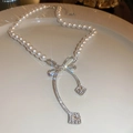 Close-up of pearl necklace featuring a sparkling rhinestone bow pendant and crystal detail - Bowknot Pearl Square Diamond Pendant (10#)