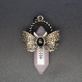 Macro shot of pink quartz hexagonal pendant with vintage bronze butterfly and black gem - Rose Quartz