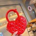 Close-up of red heart-shaped PVC jelly bag with quilted texture and glossy finish - 17*5.5*11cm / Red