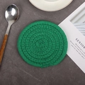 Handwoven green cotton rope coaster in a minimalist circular design for heat insulation - Green