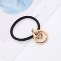 Minimalist elastic hair tie with gold double ring ornament on a stylish background card - Gold Three-Ring Cross