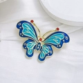 Elegant green and blue enamel butterfly brooch with gold plating and red gemstones - Blue