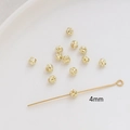 Macro detail of 4mm gold plated hollow metal spacer beads for DIY jewelry making - 4mm / 14K Gold