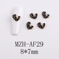 Macro detail of heart-shaped gold nail charms with black rhinestones and sizing - AF29-Gold Base Black Rhinestone Heart