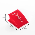 Red velvet jewelry display stand with dimensions showing a rose gold key pendant necklace - Red