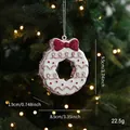 Sparkly white Christmas wreath ornament with a red glitter bow on a festive tree - Donut