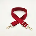 Detail of adjustable red nylon bag strap with polished gold-tone metal lobster clasps - Burgundy