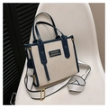 Beige canvas tote bag with dark blue leather trim and adjustable crossbody strap - Blue Small