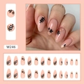 Almond pink press-on nails with black leaf patterns and gold foil flakes in long stiletto shape - Dark Leaf Shadow Gold Foil Style (W246)