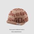 Detail der Baby-Cordmütze mit braunem Buchstabenmuster und weicher Krempentextur - 48cm (6M-2J) / Khaki