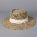 Detailed close-up of the woven texture and cream ribbon on this wide brim straw sun hat - M (56-58cm) / Off-white
