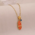 Detail shot of golden hexagon bee pendant with orange enamel and blue evil eye charm - Orange