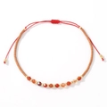 Handmade woven beaded bracelet featuring red semi-precious stones and adjustable cord - Red