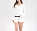 Close-up of a white V-neck cable knit sweater featuring detailed braided texture and style - S / White