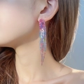 Elegant rainbow rhinestone long tassel earrings shown on model in close-up view - 3D Style / Colorful