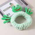 Close-up of soft mint green coral fleece frog headband with delicate embroidery detail - Headband - Green Frog Style