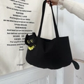 Detail of cute black cat-shaped canvas tote bag with yellow eye and collar embroidery - Small Black Cat