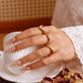 Three-piece set of 18K gold plated stainless steel wave rings worn by a model - US 7 / Assorted Styles Set / Gold