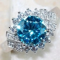 Luxurious halo ring with large round blue solitaire and pave-set diamond accents - US 5 / Blue