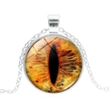 Macro detail of round glass pendant necklace featuring vibrant orange cat eye design - Silver Base - Orange Yellow Cat Eye