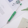 DIY green beaded ballpoint pen with ergonomic body and metallic tip in creative setting - Green