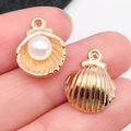 Golden shell alloy pendant featuring an internal pearl and detailed back texture - KC Gold Pearl Shell