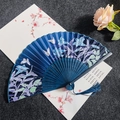 Navy blue silk folding fan with white butterfly and lily patterns and a matching tassel - Blue Lily - Blue Handle