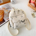 Mini cream corduroy backpack featuring black embroidered smiley faces and front flap pocket - Off White