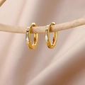 18k gold plated twist hoop earrings with sparkling cubic zirconia on a wooden branch - Gold Twisted Zircon Geometric Earrings