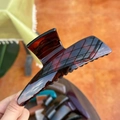 Macro shot of large butterfly hair claw clip with tortoise shell pattern in hand - XL Butterfly Buckle (Approx. 13.5cm) / Glossy Red Brown