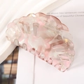 Macro detail of a shell-shaped pink marble acetate hair claw clip for women - 8.2cm / Pink