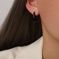 Minimalist black enamel teardrop earrings with gold finish, shown on model - Black
