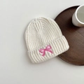 Close-up of beige cable knit beanie with embroidered pink bow and thick texture - 3-8 Years / White