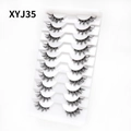 Macro shot of 10 pairs of black cat-eye half eyelashes model XYJ35 on a white tray - Curled Voluminous Style (XYJ35) / 10 Pairs Set